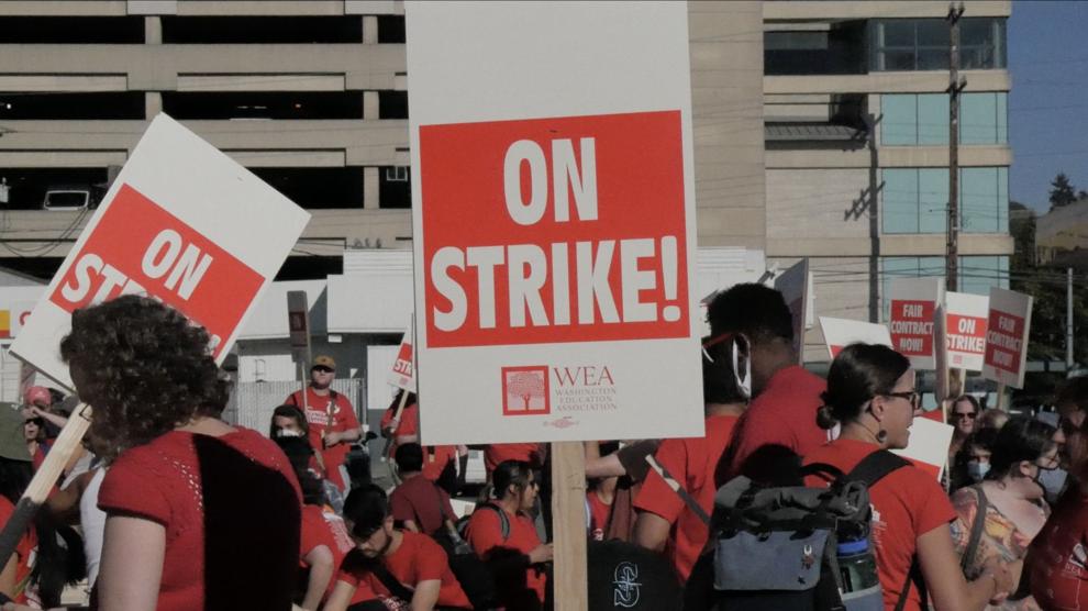 A sign reading "On Strike" is held by a participant during a strike. Photo: Spencer Pauley / The Center Square